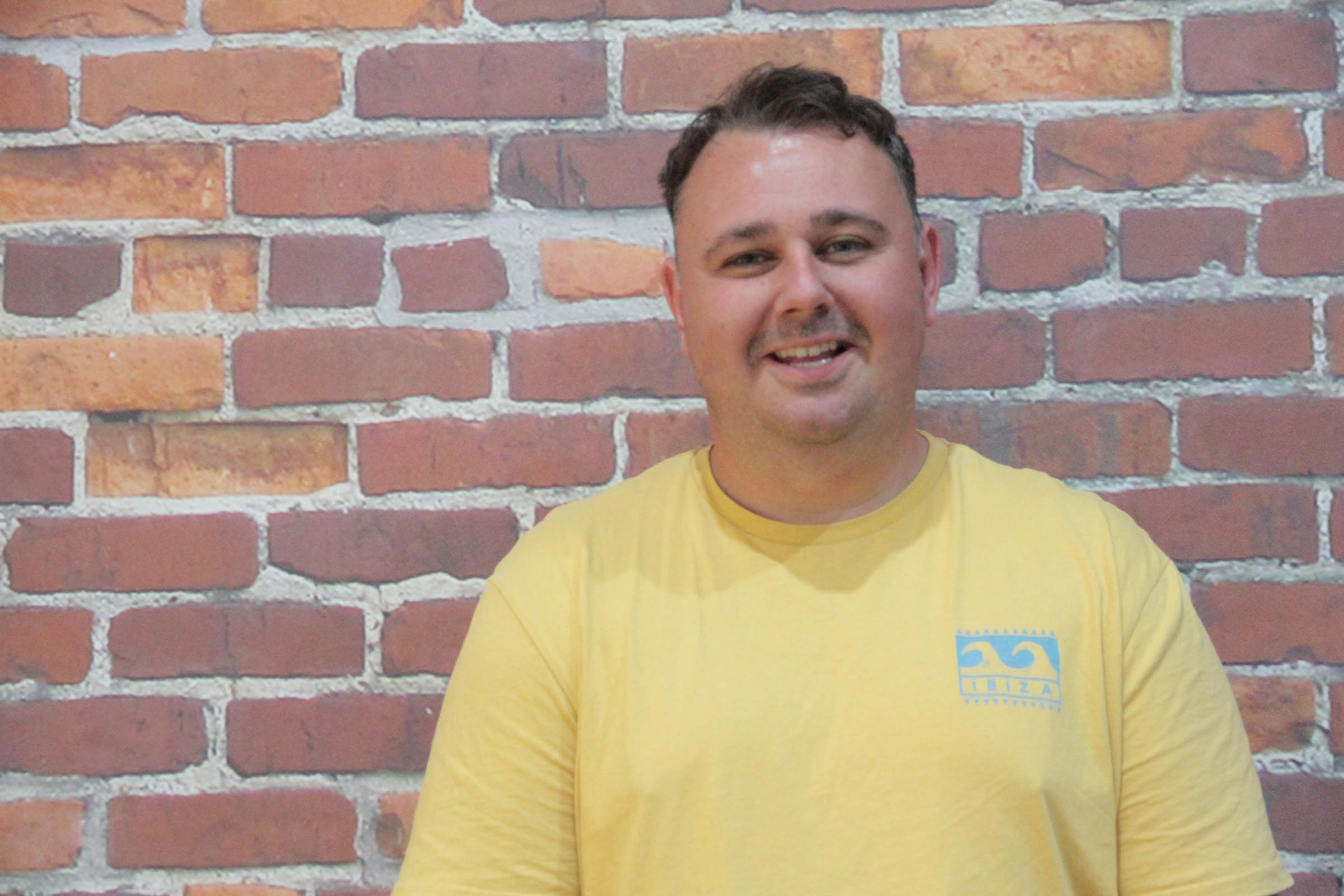 Ategi&#x27;s support worker, James. smiling at the camera.  