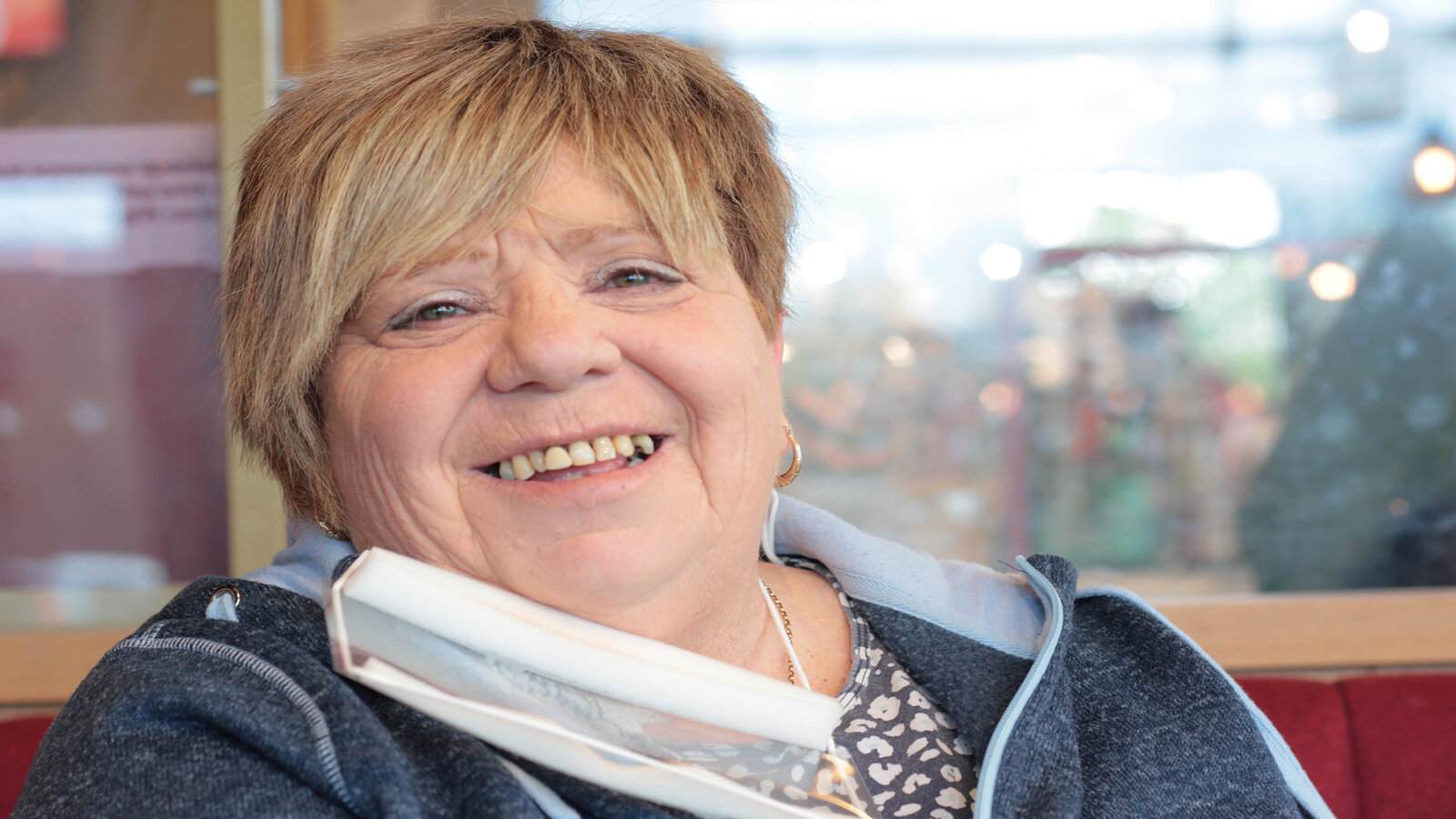 A female support worker lookng at the camera smiling. 