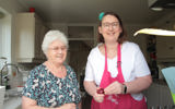Wendy cooking with her Shared Lives carer, Grazelda. Both women are smiling at the camera.
