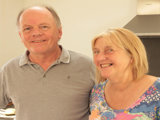 Martin and Liz smiling at the camera in their kitchen. 
