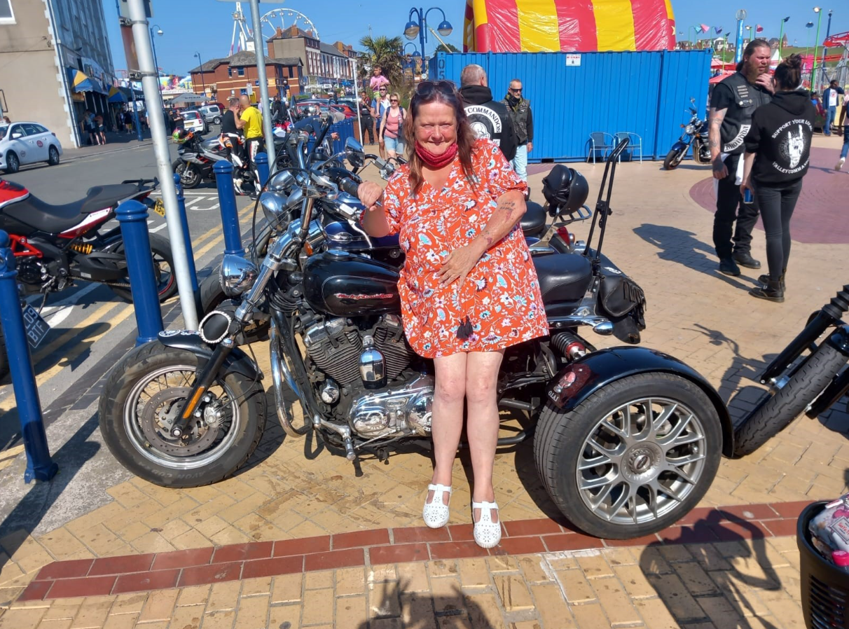 Gina sat with lots of motorbikes all around her. She is sat on a motorbike. 