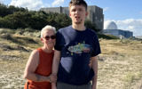 Kim and Josh stood on a beach. Kim is a small older lady and Josh is young and much taller than she is. 