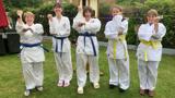 A group of women dressed ready to do martial arts. 