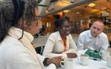 Mp Neil Coyle talking to a Shared Lives carer, Lorna and person we support, Miriam at Westminster.