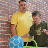 Richie, a youn man with learning disailities who is being supported to do some bowling with his support worker.